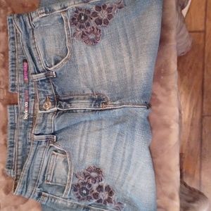 Embroidered and distressed blue jeans